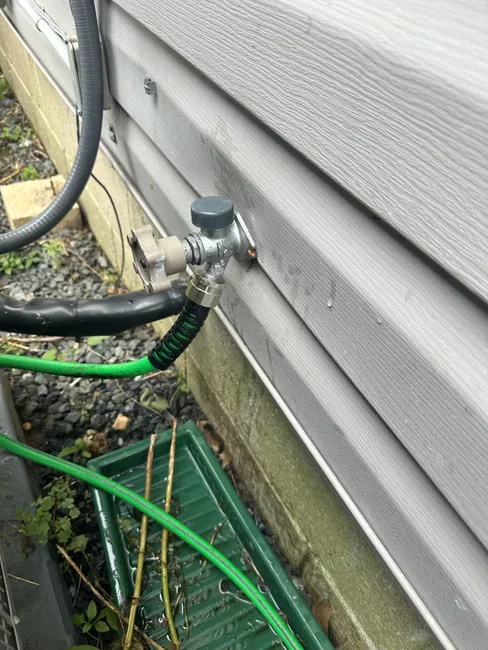 We relocated a frost-free hose bib for better accessibility, sealing the old hole and installing a new valve.