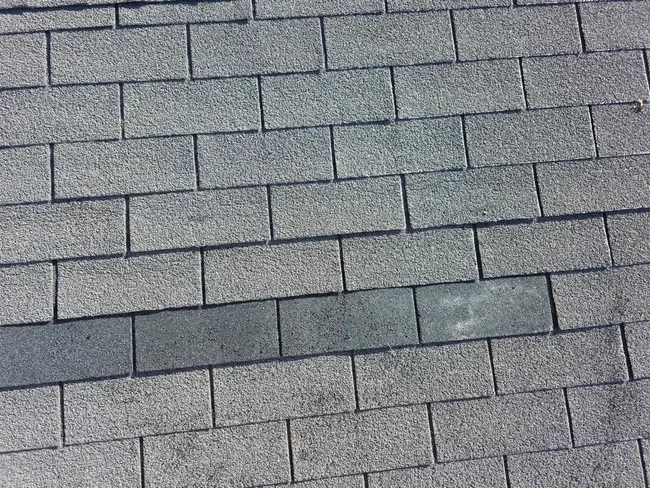 Wind damage led to a roof replacement using Timberline HDZ shingles, restoring structural integrity for the homeowner.