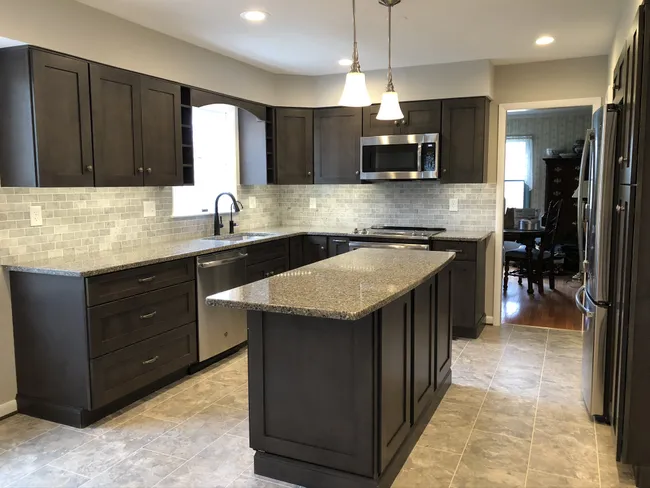 Removing the wall enhanced the flow between the kitchen and family room, creating a bright, inviting atmosphere.