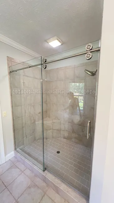 At a residential property, we modernized an outdated shower with a sleek crescent slider and elegant glass.