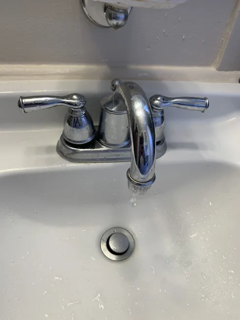 A stylish new faucet replaced an old, leaky model, enhancing both function and aesthetics in the bathroom.