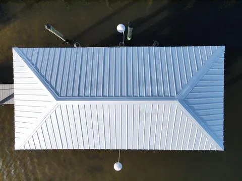 Our team installed 26-gauge rib panel metal on a new boathouse, enhancing its durability and aesthetics.
