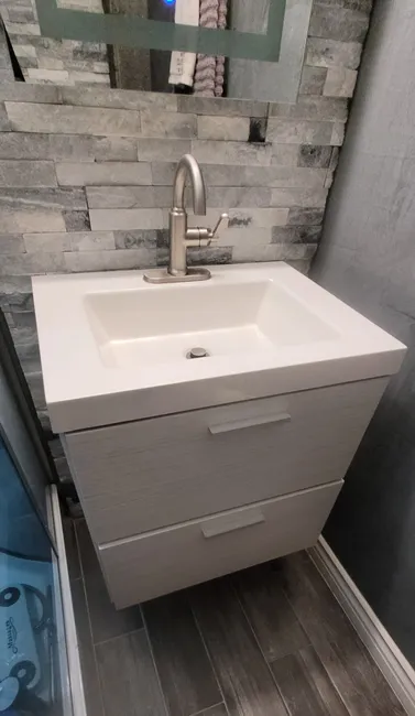 We modernized the bathroom by installing a new vanity sink and faucet, enhancing both functionality and style.