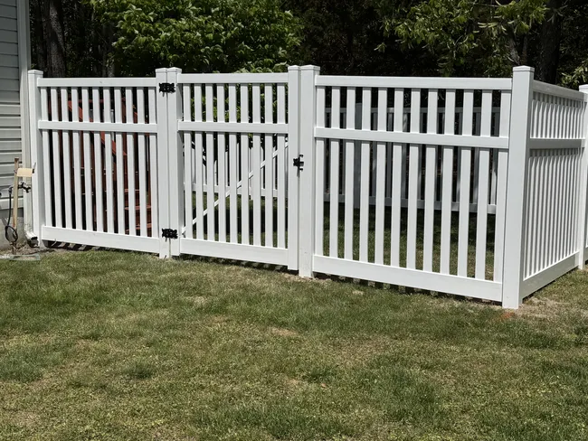 A 6-foot vinyl picket fence was installed, enhancing safety and style for the dogs’ play area.