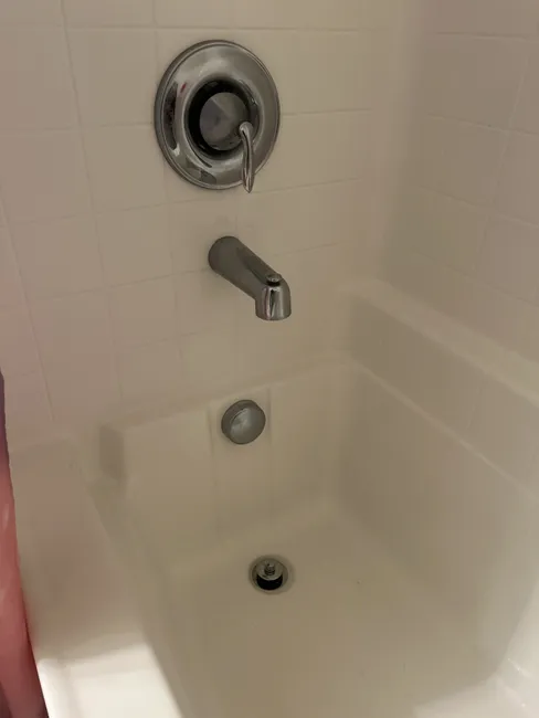 Standing water in the upstairs tub and shower was quickly resolved by clearing the clogged drain, restoring functionality.