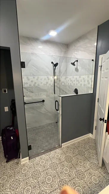 A stylish upgrade was achieved with the installation of an elegant 3-panel glass shower enclosure, featuring durable 3/8