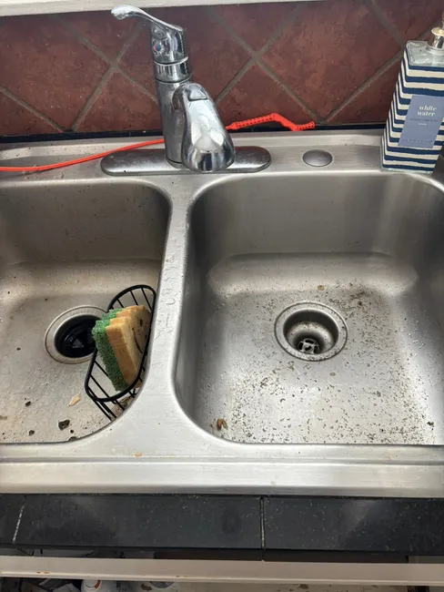 A blocked kitchen sink was resolved by clearing a penny from the garbage disposal, restoring flow efficiently.