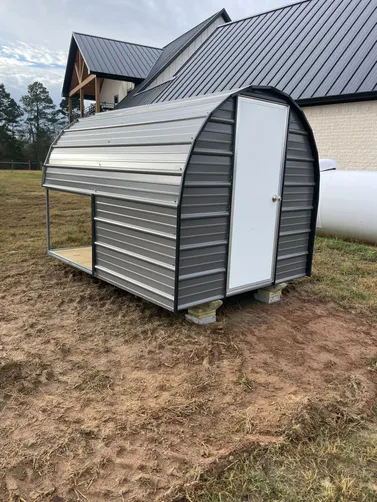 photo at Ore City, TX on Jan 09, 2026: 8x12 open animal shelter in charcoal with black trim 6x8 dog house(solid floor, enclosed back room
