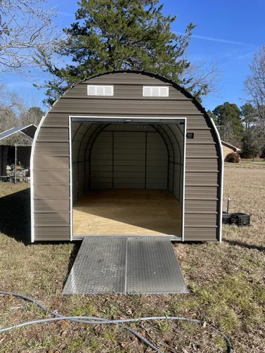 photo at Diana, TX on Jan 19, 2026: 10x20 Round Top Storage Building with 6'wide roll up door, set of aluminum ramps-Burnished Slate-