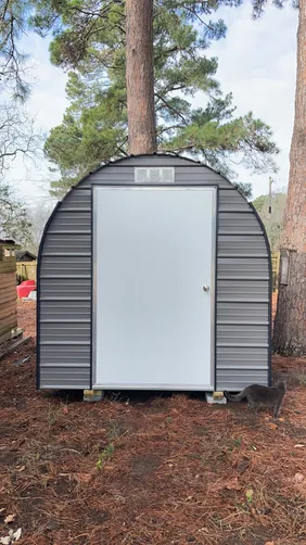 photo at Naples, TX on Jan 22, 2026: 8x12 Round top storage building with 4' wide swing open doorCharcoal Gray w/ Black trim-treated 
