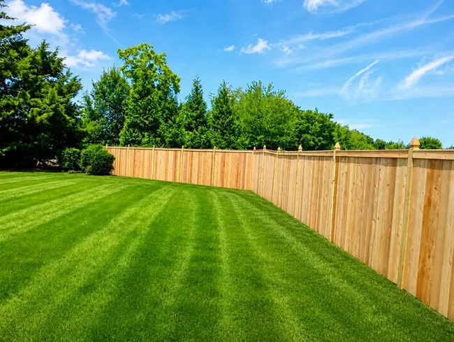A custom cedar privacy fence was installed, enhancing security and aesthetics for the homeowner.