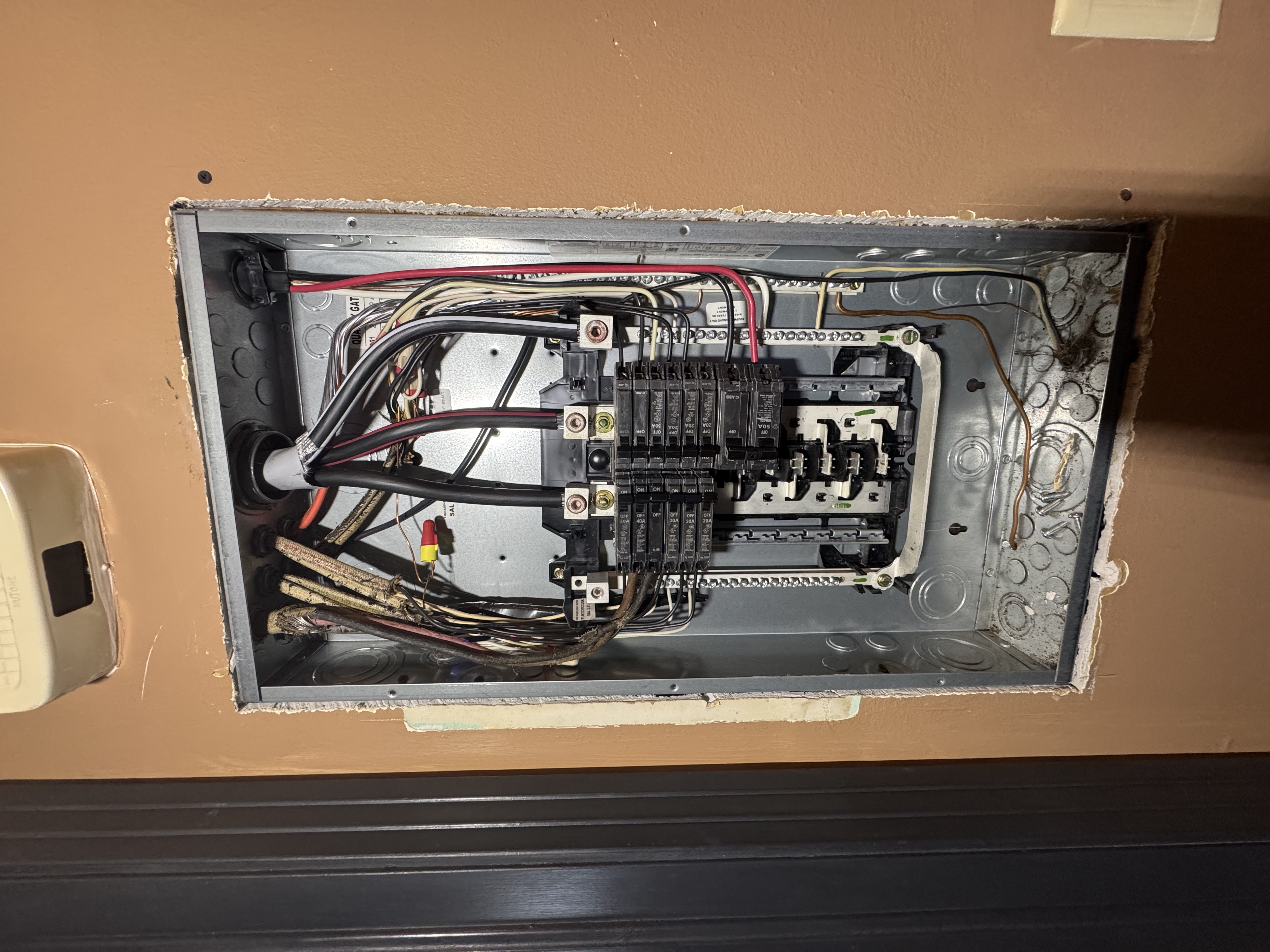 Electrical panel inspected by Rider Electric at a St. Augustine home after an insurance report flagged cloth wiring