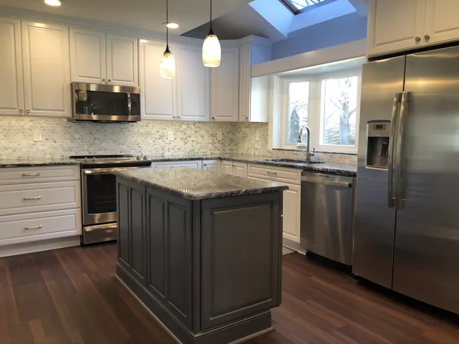 A spacious, modern kitchen emerged as we removed soffits, upgraded cabinets, and enhanced lighting throughout.