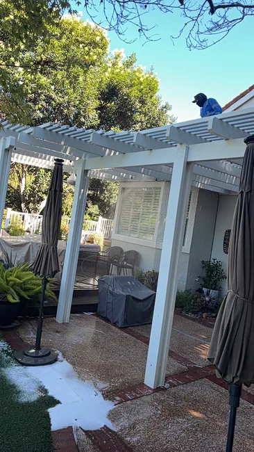 We refreshed the white pergola with a soft wash, removing mold and dirt to enhance its inviting appearance.