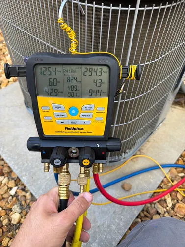 Diagnostic gauges connected to an outdoor unit during a Vestavia Hills service visit