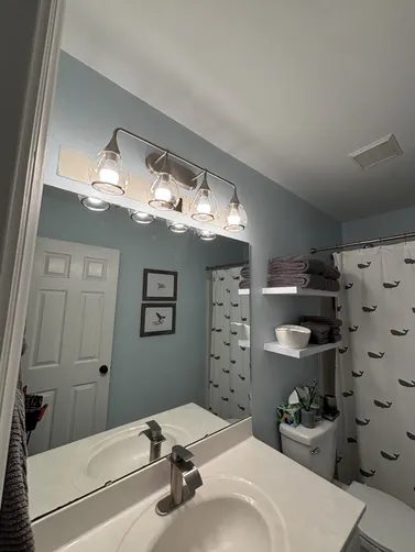 Move a small bathroom light fixture up a few inches & installed a new old work box.