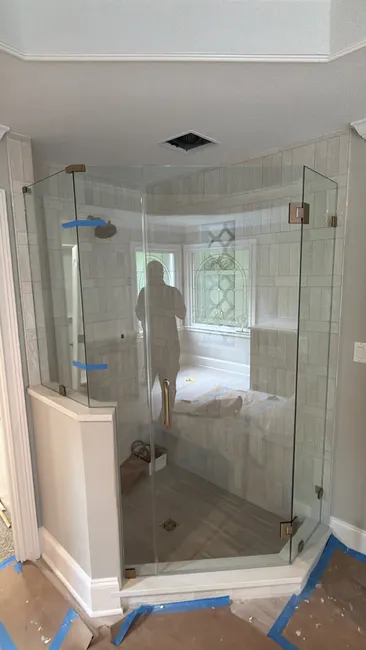 A sleek 4-panel frameless shower enclosure was installed, enhancing this residential bathroom's elegance and functionality.