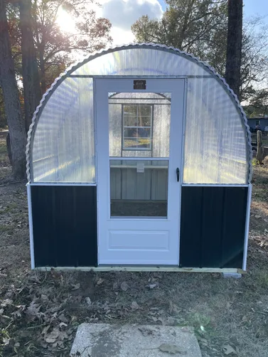 photo at Longview, TX on Dec 12, 2025: 8x10 greenhouse with black wainscotFiberglass top, metal sides, treated shelving, walk in door, sl