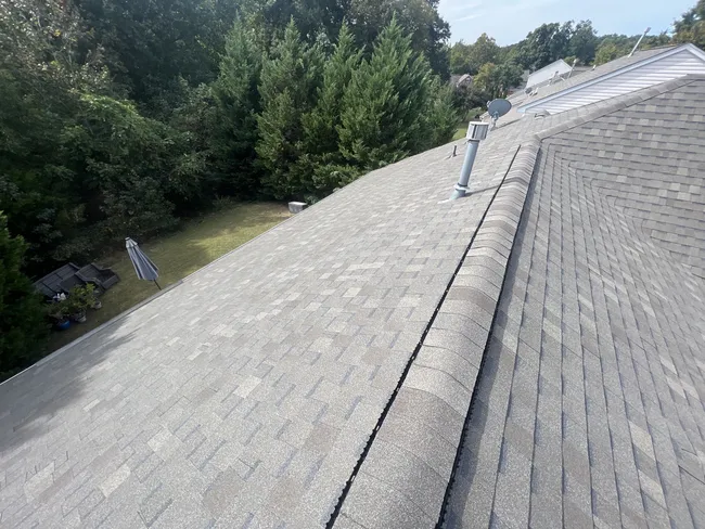 We just finished installing new architectural asphalt shingles from Atlas. These Pinnacle Pristine shingles feature 3M technology that resists algae growth for the life of the shingle. We are doing the final inspection.