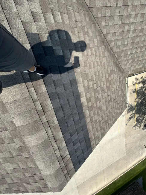 Restoring integrity to a commercial roof, we tackled wind-damaged shingles and repaired pipe boots effectively.