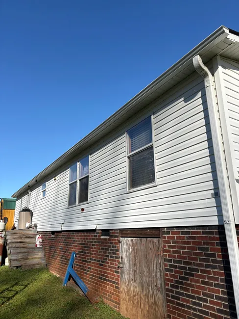 New 5-inch seamless gutters were installed to enhance drainage for a residential property in Statesville, ensuring durability with quality American materials.