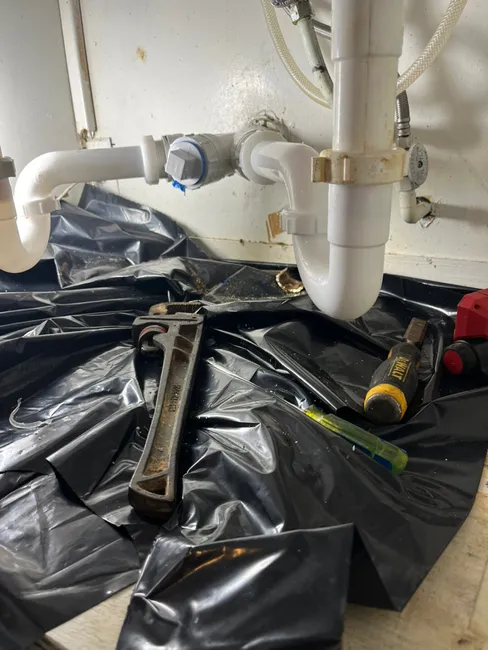 Cutting out a cracked kitchen drain, we expertly installed a durable PVC system for long-lasting reliability.