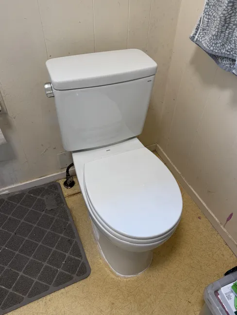 A dated toilet was replaced with an efficient model, while a new stylish kitchen faucet enhanced functionality.
