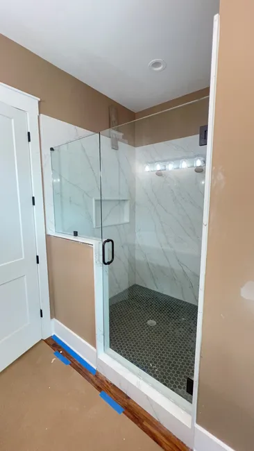Transformed the bathroom with a stunning master shower, featuring elegant glass panels and oil-rubbed bronze accents.