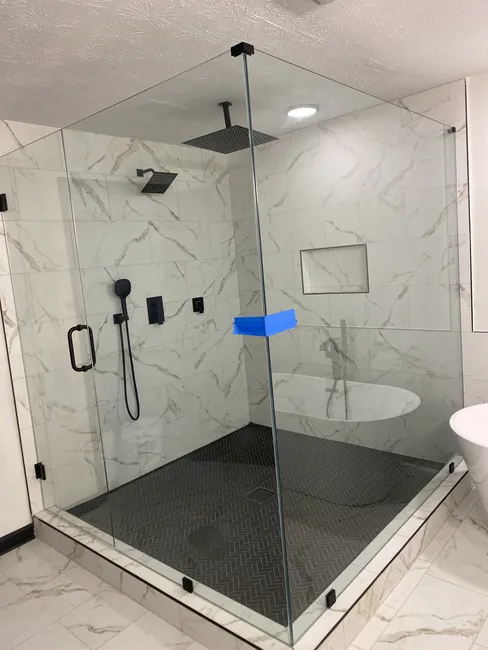 2 and 3 Panel Frameless Glass Shower Enclosures, both with Matte Black Hinges, Clips, and Handles