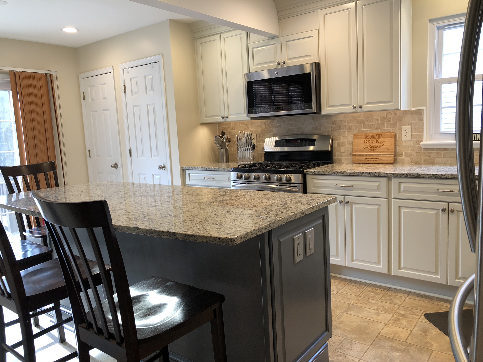 Kitchen island with overhang lighting and recessed lights in Columbia, MD