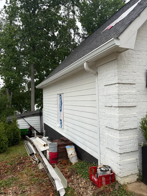 At a residence in Mooresville, we installed 6-inch seamless gutters, reusing downspouts and reinstalling gutter guards for optimal performance.