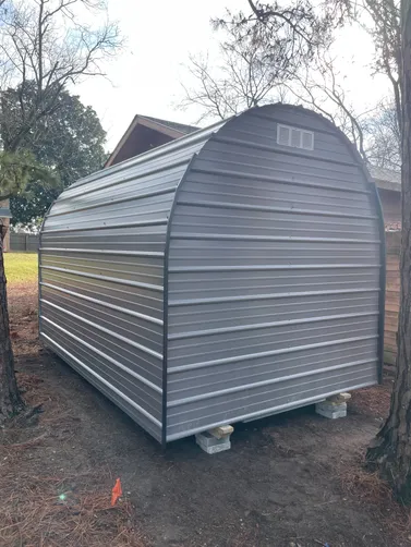 photo at Naples, TX on Jan 22, 2026: 8x12 Round top storage building with 4' wide swing open doorCharcoal Gray w/ Black trim-treated 
