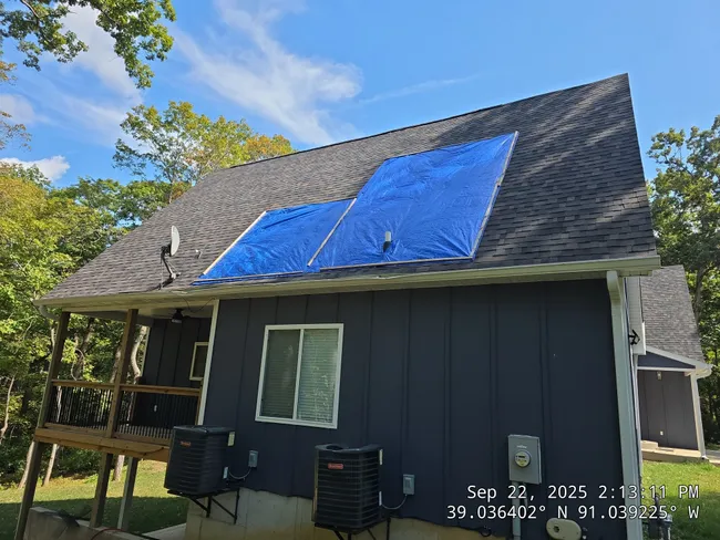 After storm damage in Troy, we secured a roof tarp to prevent water intrusion and protect the home.