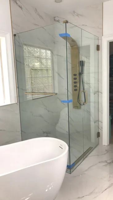 A beautiful three-panel swing door shower with clear tempered glass was expertly installed, enhancing the bathroom's style and functionality.