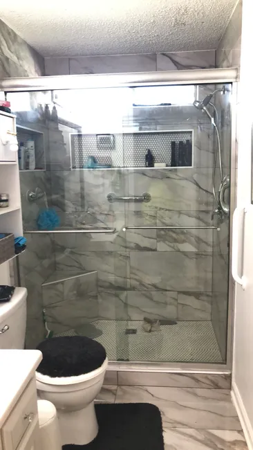 Elevating a residential bathroom, we installed a sleek 57 x 74 glass shower featuring polished edges and sophisticated hardware.