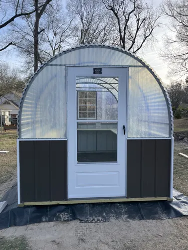 photo at Marshall, TX on Jan 20, 2026: 8x12 Greenhouse with welded steel frame, treated shelving, window, storm doorBurnished Slate with 