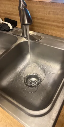 photo at Houston, TX on Dec 03, 2025: A leak was identified from one of the two basket strainers under the kitchen sink, prompting the ne