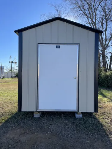 photo at Kilgore, TX on Jan 15, 2026: 8x12 gable storage building in Lightstone with black trim4' wide man door, solid flooring, welded 