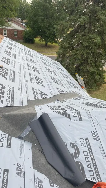 In Saint Ann, we upgraded the roofing with charcoal GAF Timberline HDZ shingles and fitted white drip edges, ensuring lasting protection and style for the homeowner.