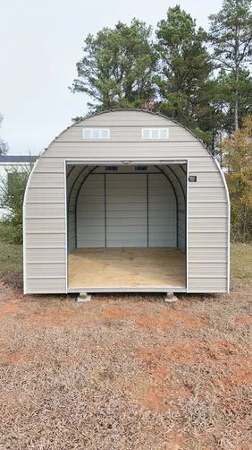 photo at Ore City, TX on Dec 16, 2025: 10x16 round top storage building in taupe with white trimAll welded steel frame, solid flooring wi