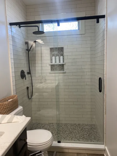 2 Panel Frameless Sliding Glass Shower - this is called a Hydroslide and is a Matte Black Finish