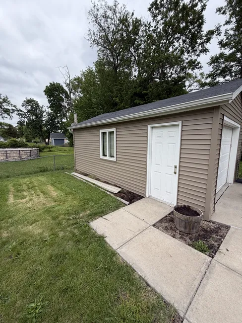 We replaced old siding with new vinyl on the home and garage, ensuring lasting durability and enhanced curb appeal.