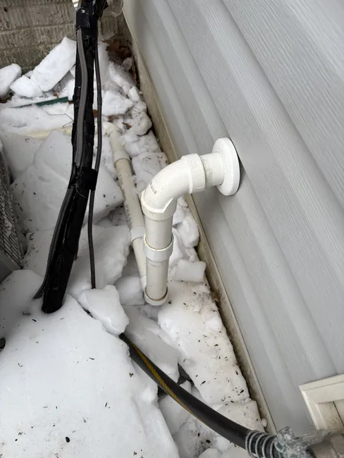 A frozen sump pump discharge line was cut out to restore efficient flow, ensuring optimal performance for the home.