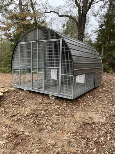 photo at Carthage, TX on Dec 12, 2025: 10x12 dog kennel in charcoal with black trimSolid floor, welded frame, welded kennels in back room