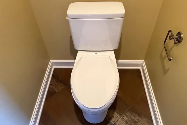 An outdated toilet was replaced with a new Toto fixture, ensuring a secure, leak-free installation for the homeowner.