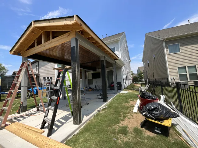 New seamless gutters and downspouts were installed on this Mooresville porch, enhancing both style and durability.