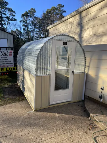 photo at Longview, TX on Jan 15, 2026: 6x10 greenhouse with Lightstone wainscotFiberglass top, metal sides, door with sliding glass windo