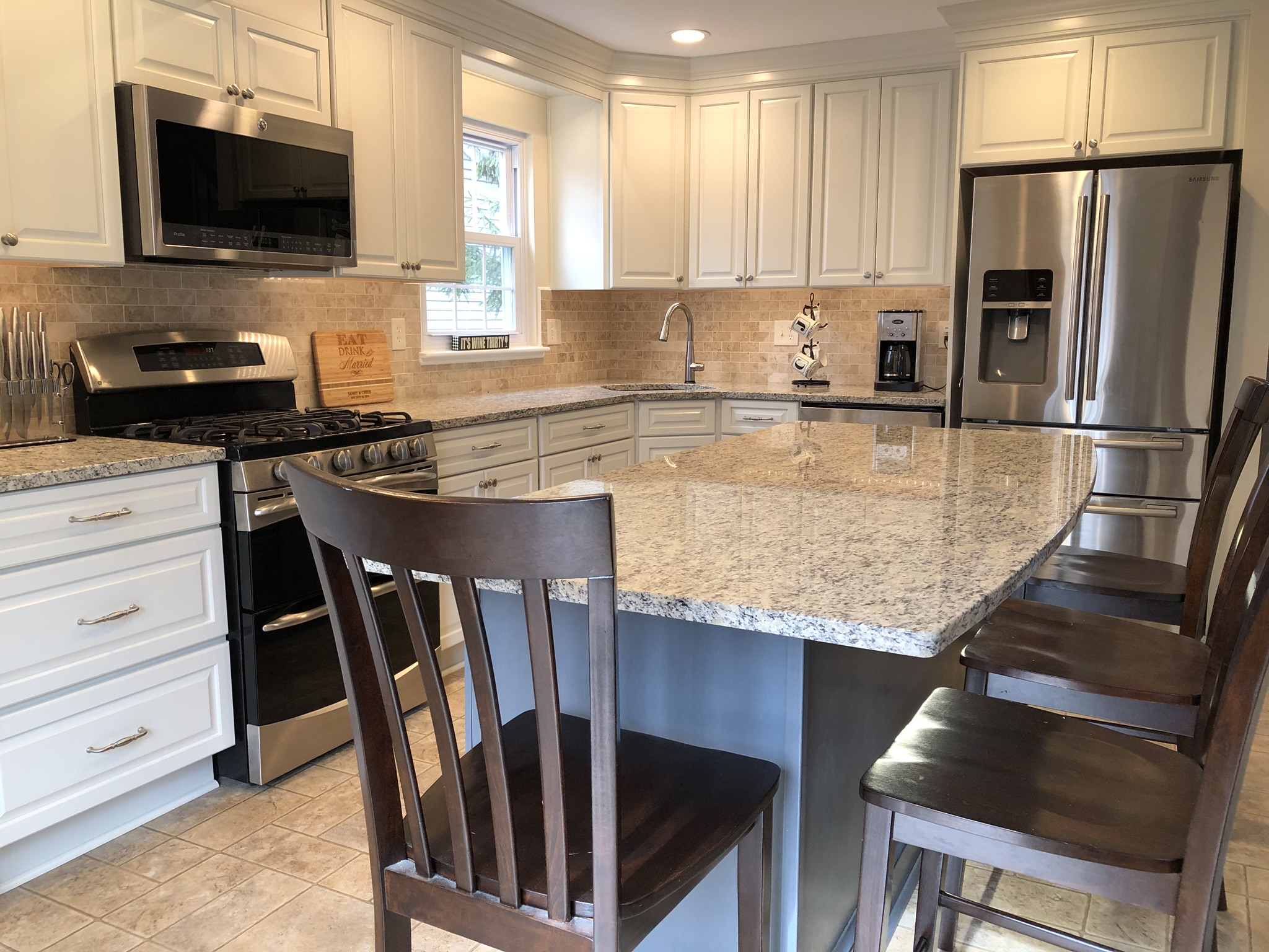 Remodeled kitchen in Columbia, MD with wall cabinets run to the ceiling and granite countertops