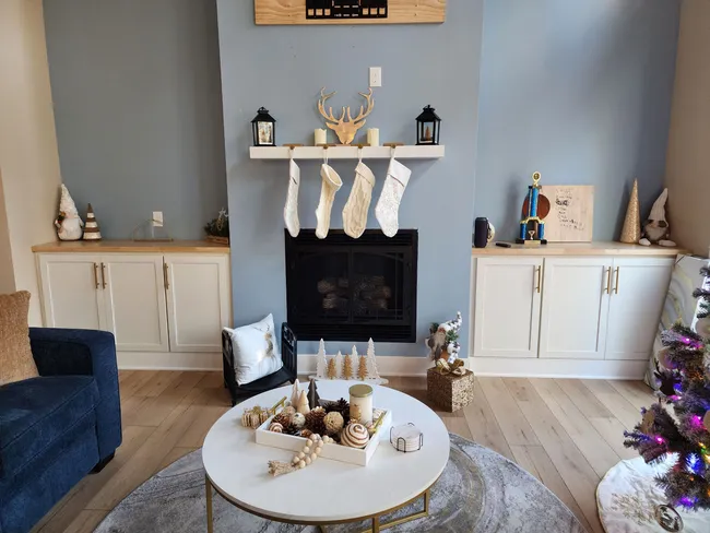 An outdated living space was rejuvenated with an open concept, modern fixtures, and stylish finishes.