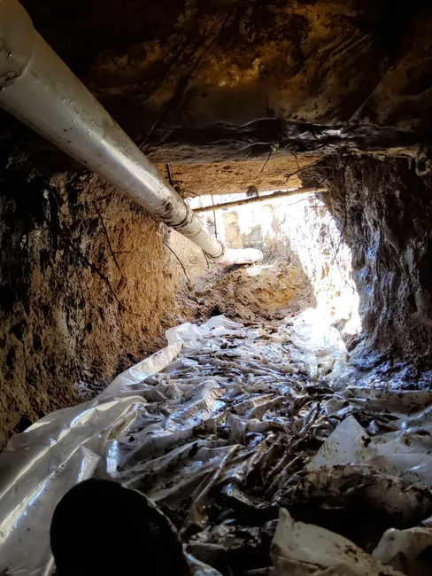 To resolve a plumbing issue, we tunneled into the half bathroom, rerouting the sewer line for a secure connection.